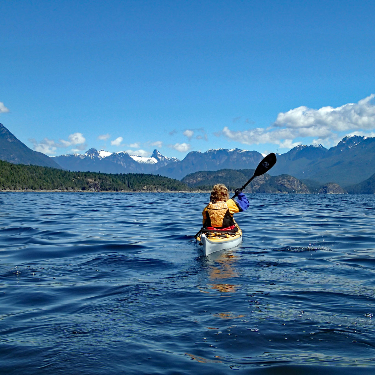 Woman kayaking in Desolation Sound, BC