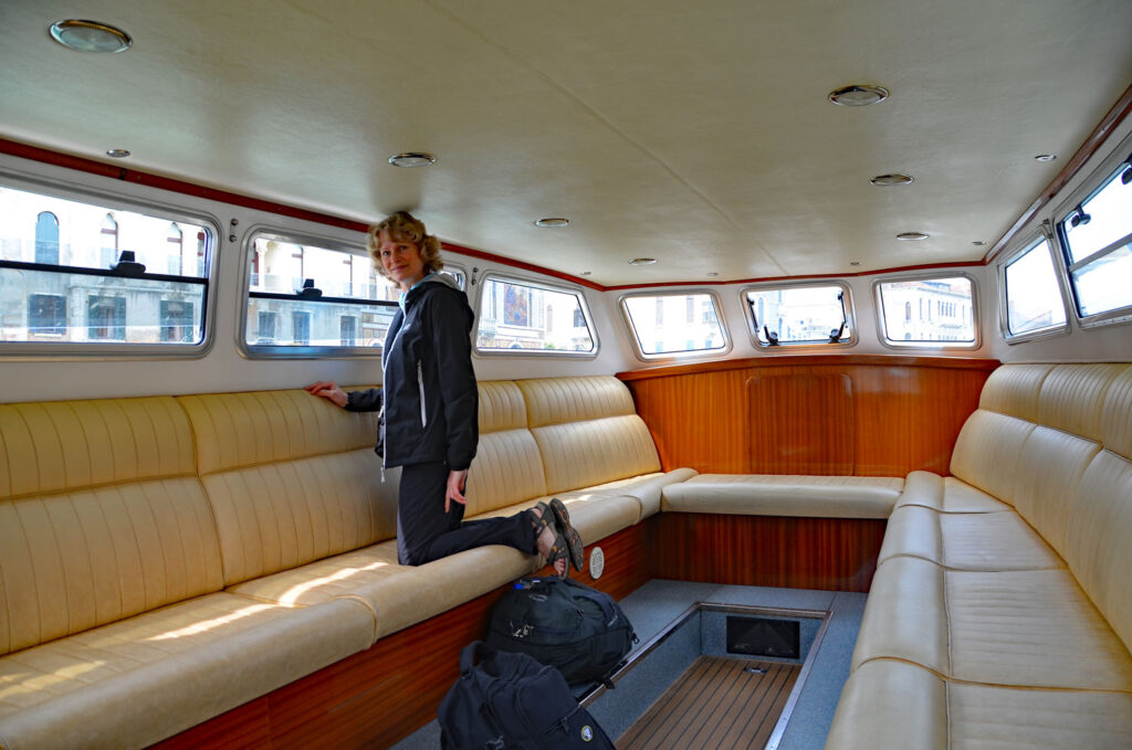 Mary in interior of water taxi in Venice, Italy